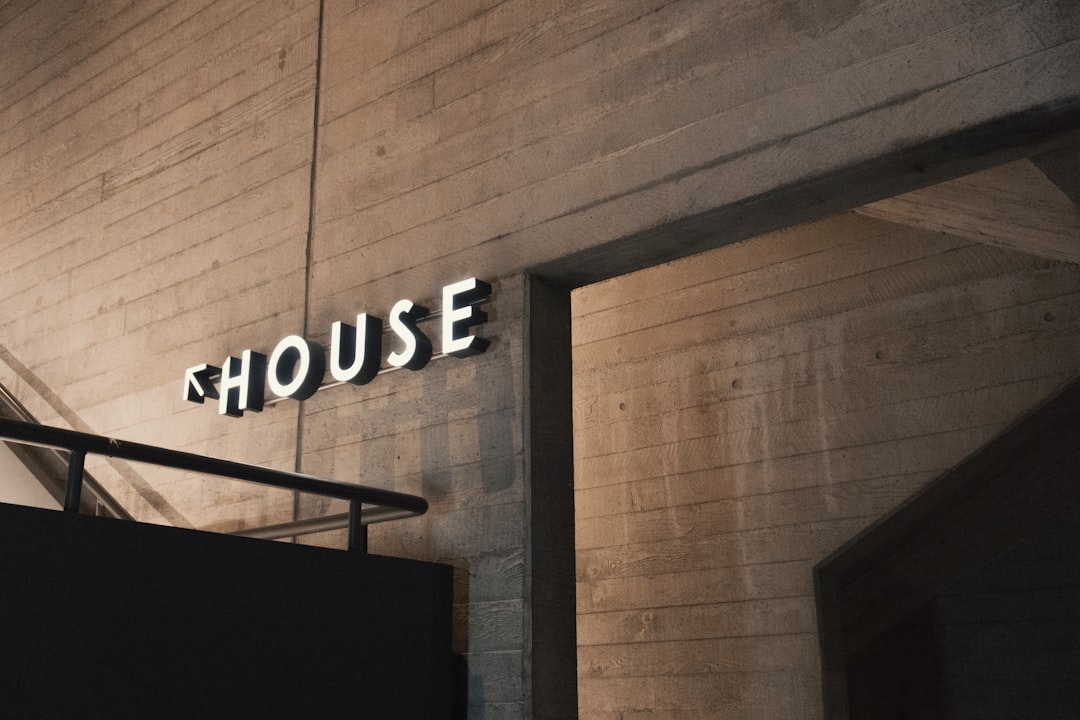 Modern metal business sign with LED lighting on a storefront wall