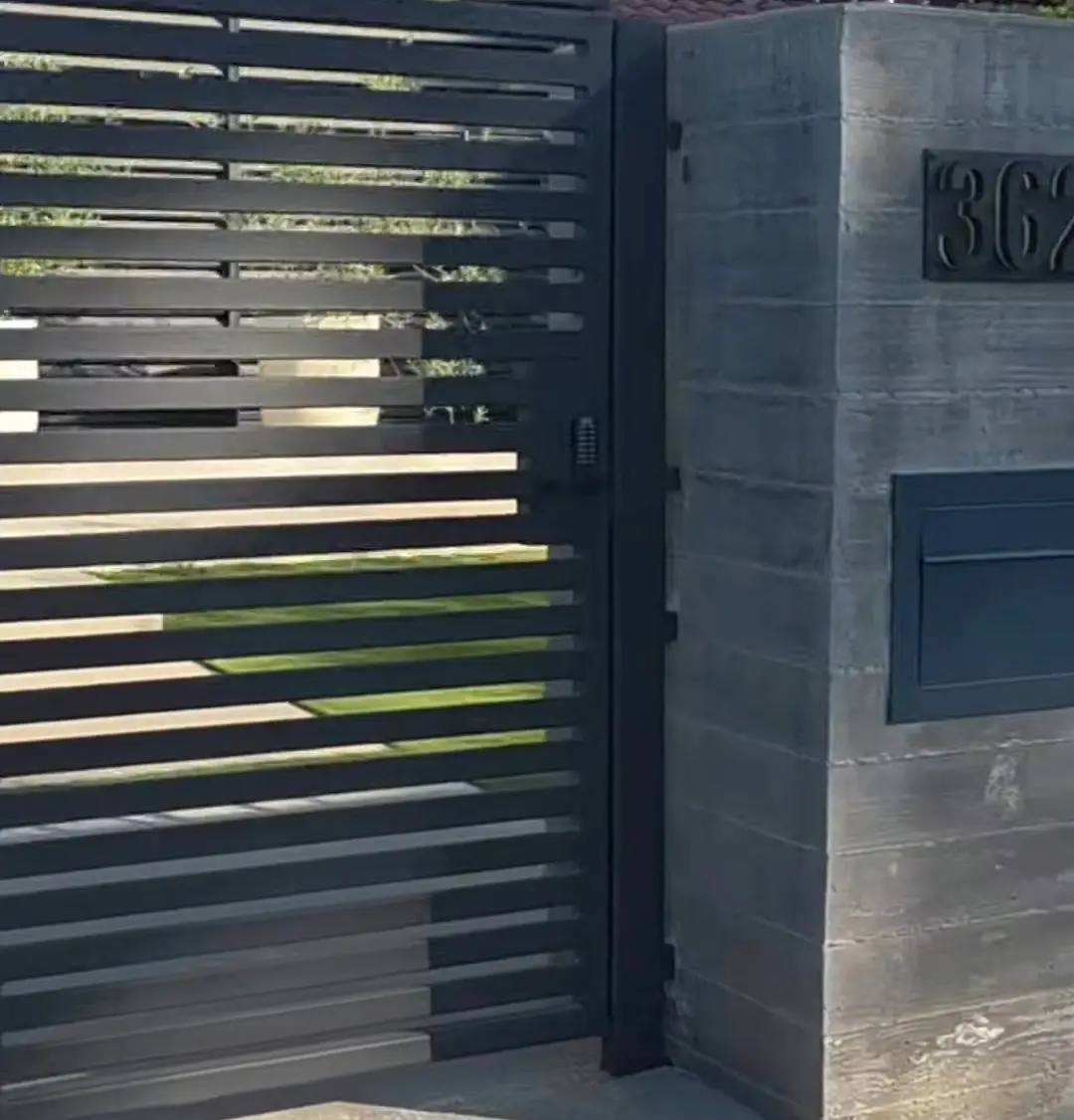 Heavy-duty horizontal iron fence custom-designed and installed for a modern Santa Monica home.